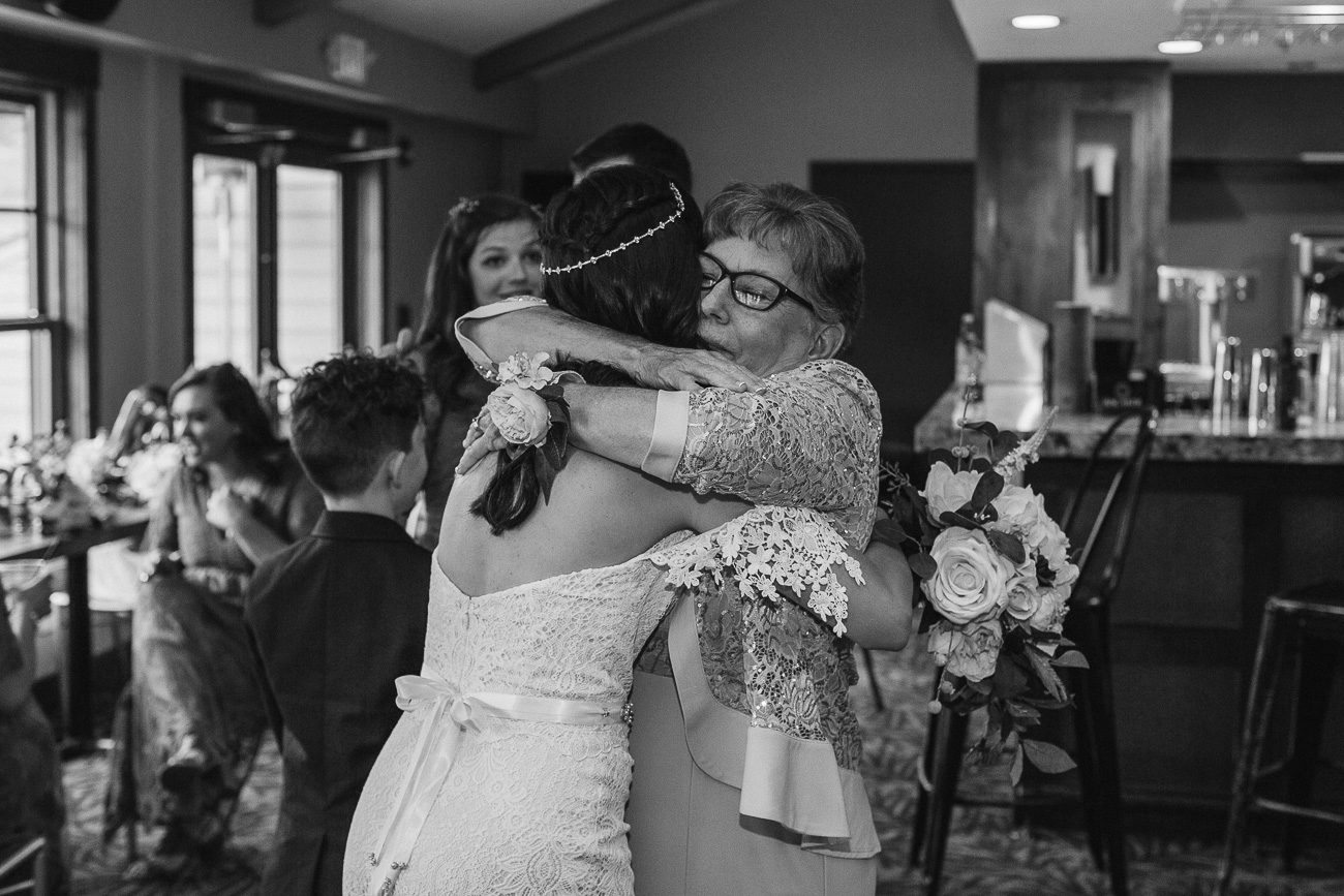 Mother of the groom hugging bride