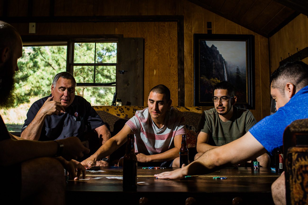 Guys playing poker at Spruce Mountain Ranch