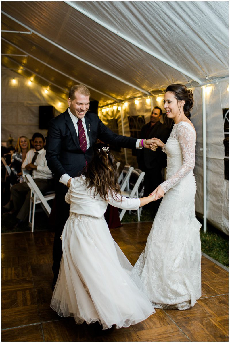 Bride and Groom dancing with daughter at wedding