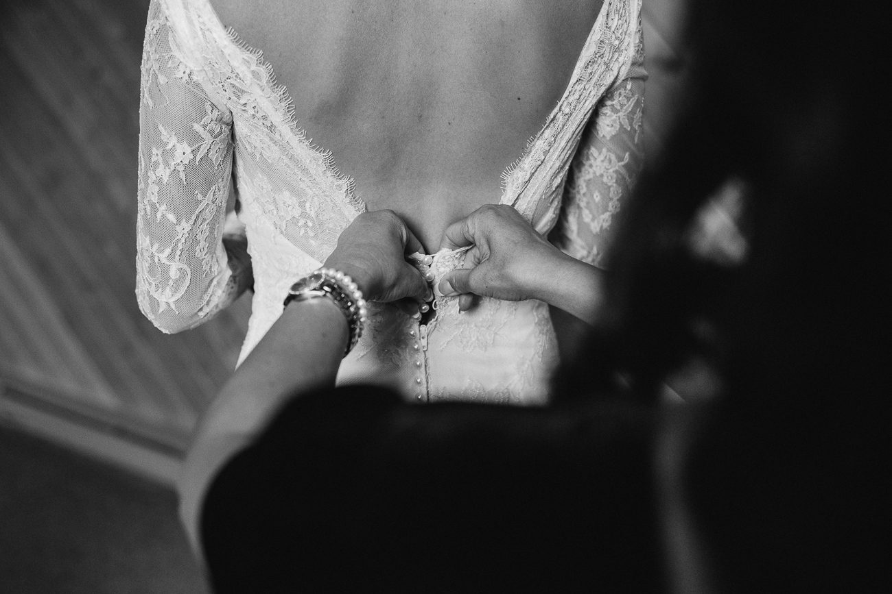 Zipping up bride's dress