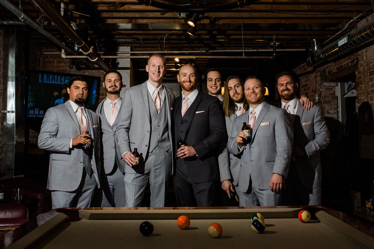 Groomsmen picture hanging out in man cave on wedding day