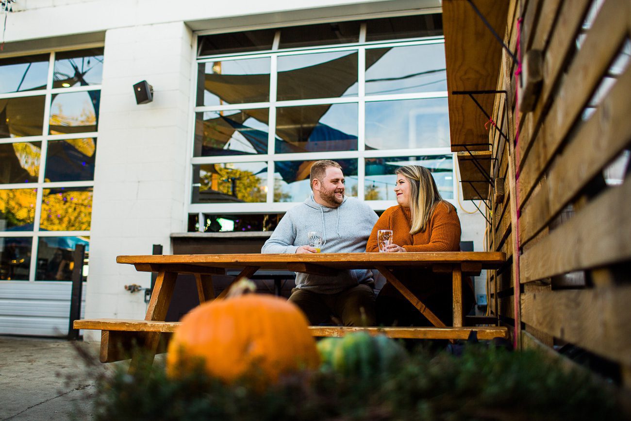 Fall engagement photo at brewery