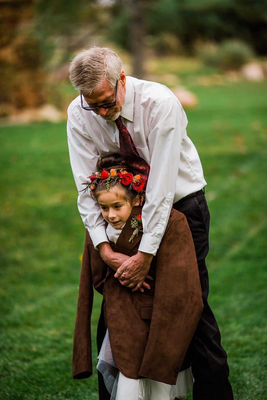 Grandpa hugging flower girl