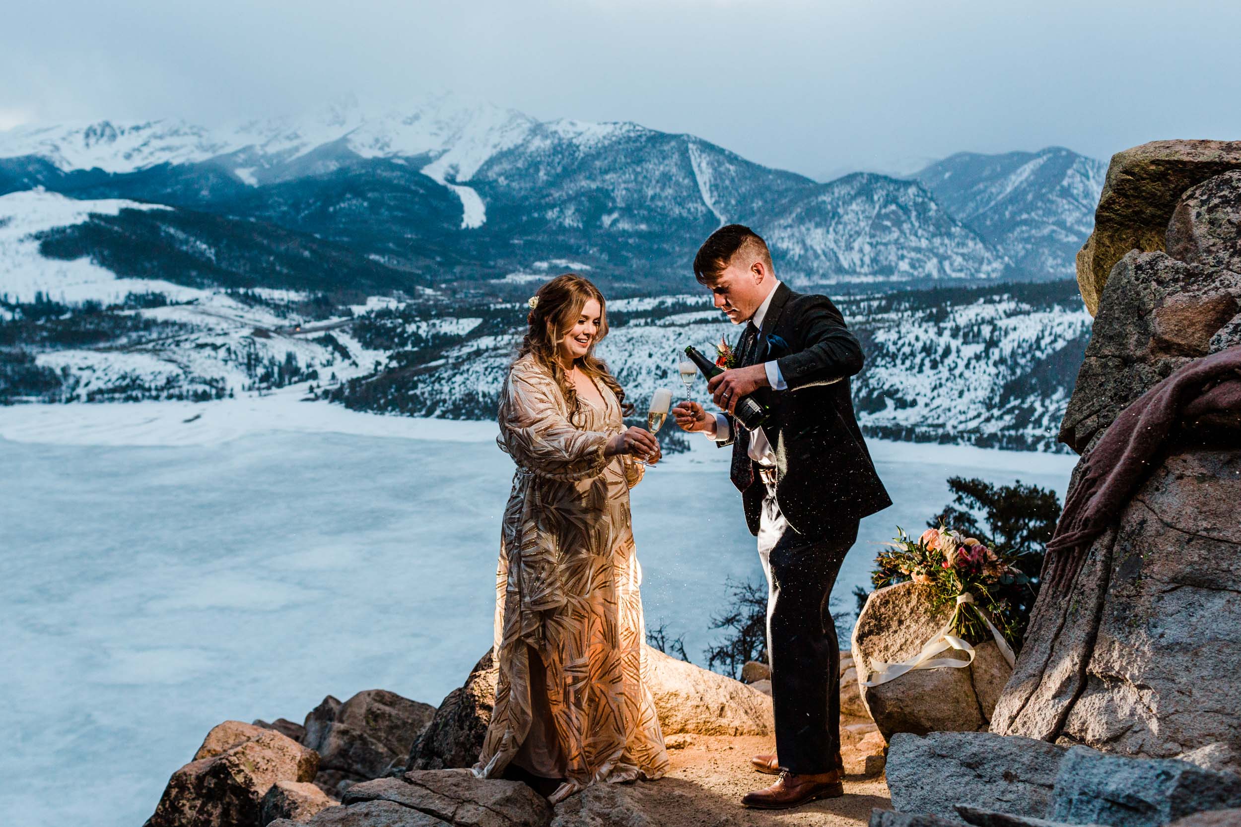 Popping champagne at elopement
