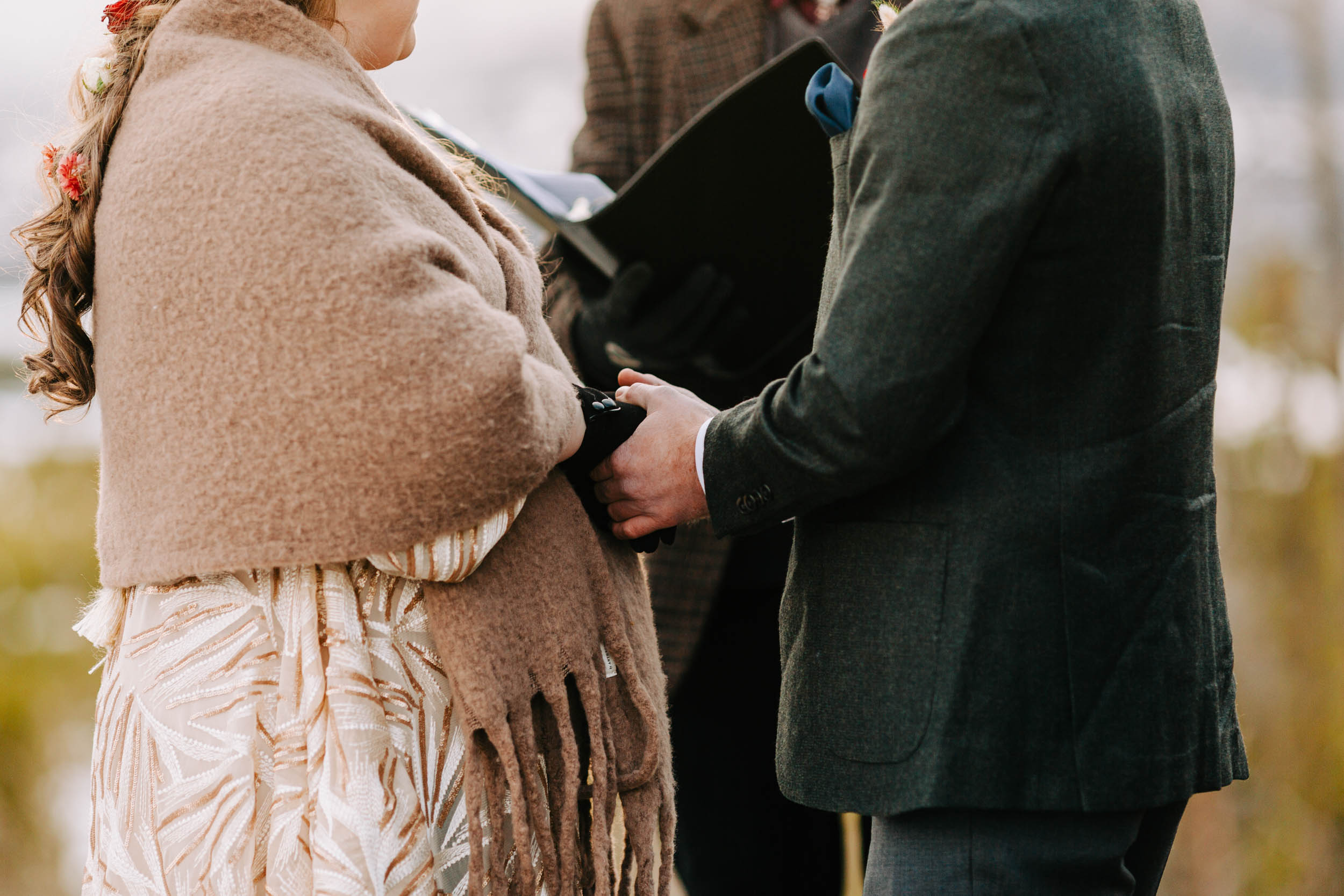 Couple holding hands at elopement