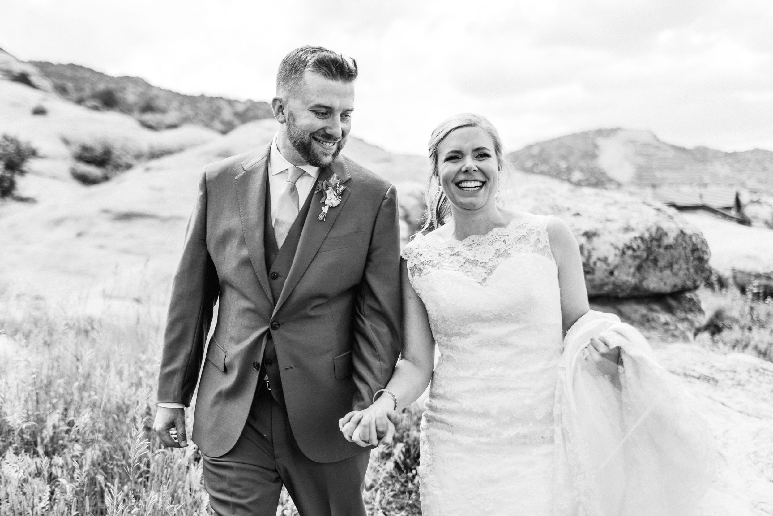 wedding couple walking towards camera laughing by Shea McGrath Photography Denver Colorado Wedding Photographer