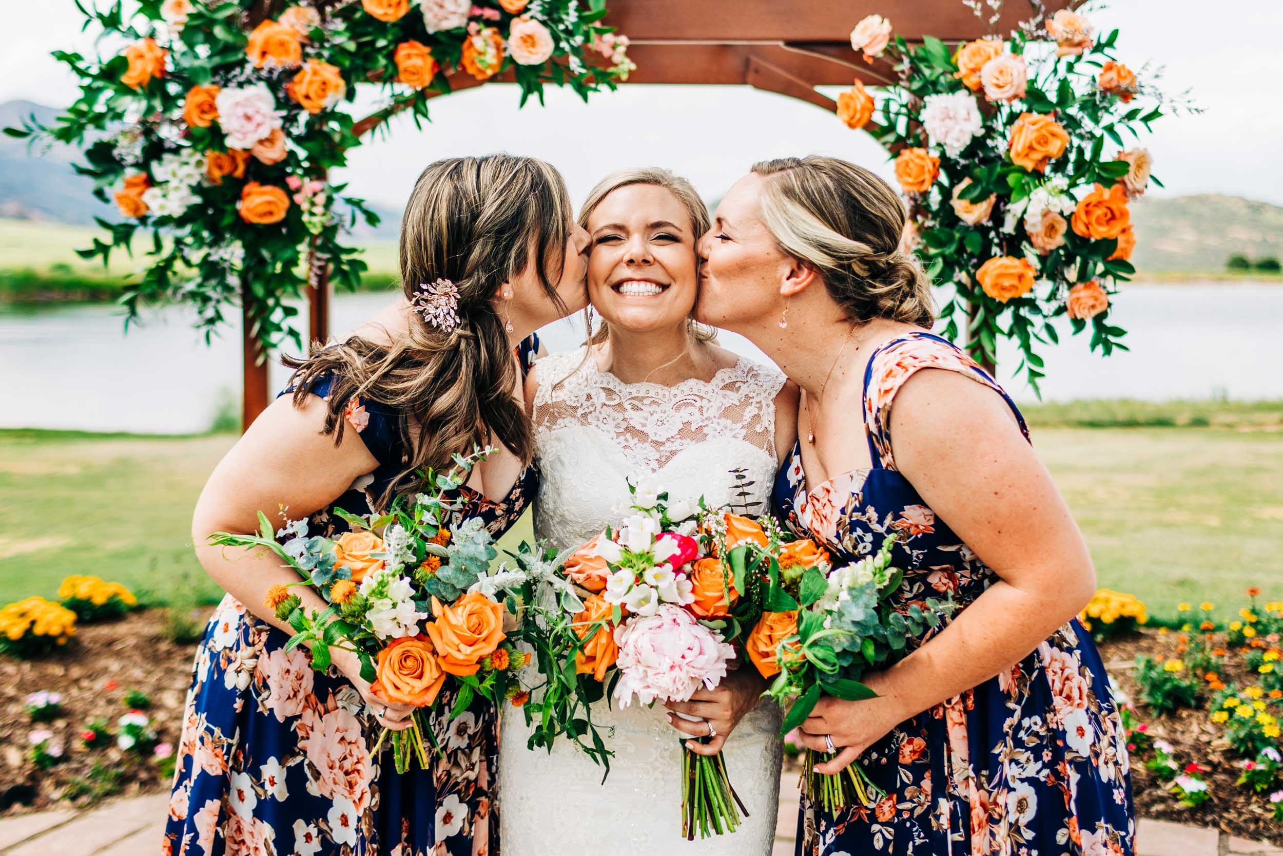 bridesmaids kissing bride's cheek by Shea McGrath Photography Denver Colorado Wedding Photographer