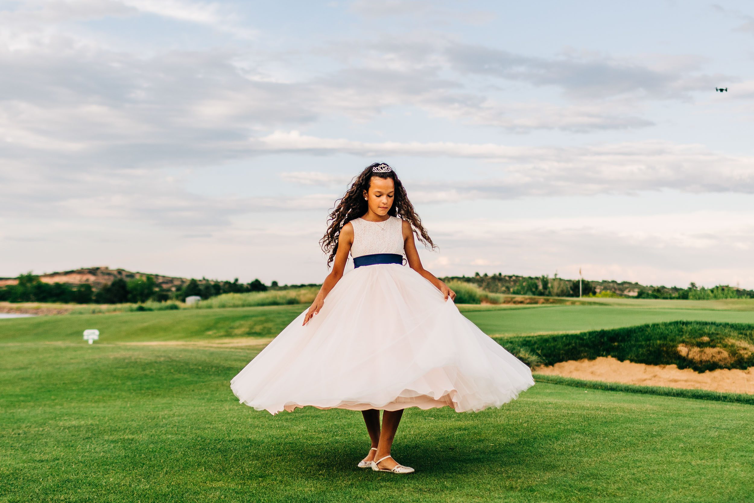 flower girl twirling in her dress by Shea McGrath Photography Denver Colorado Wedding Photographer