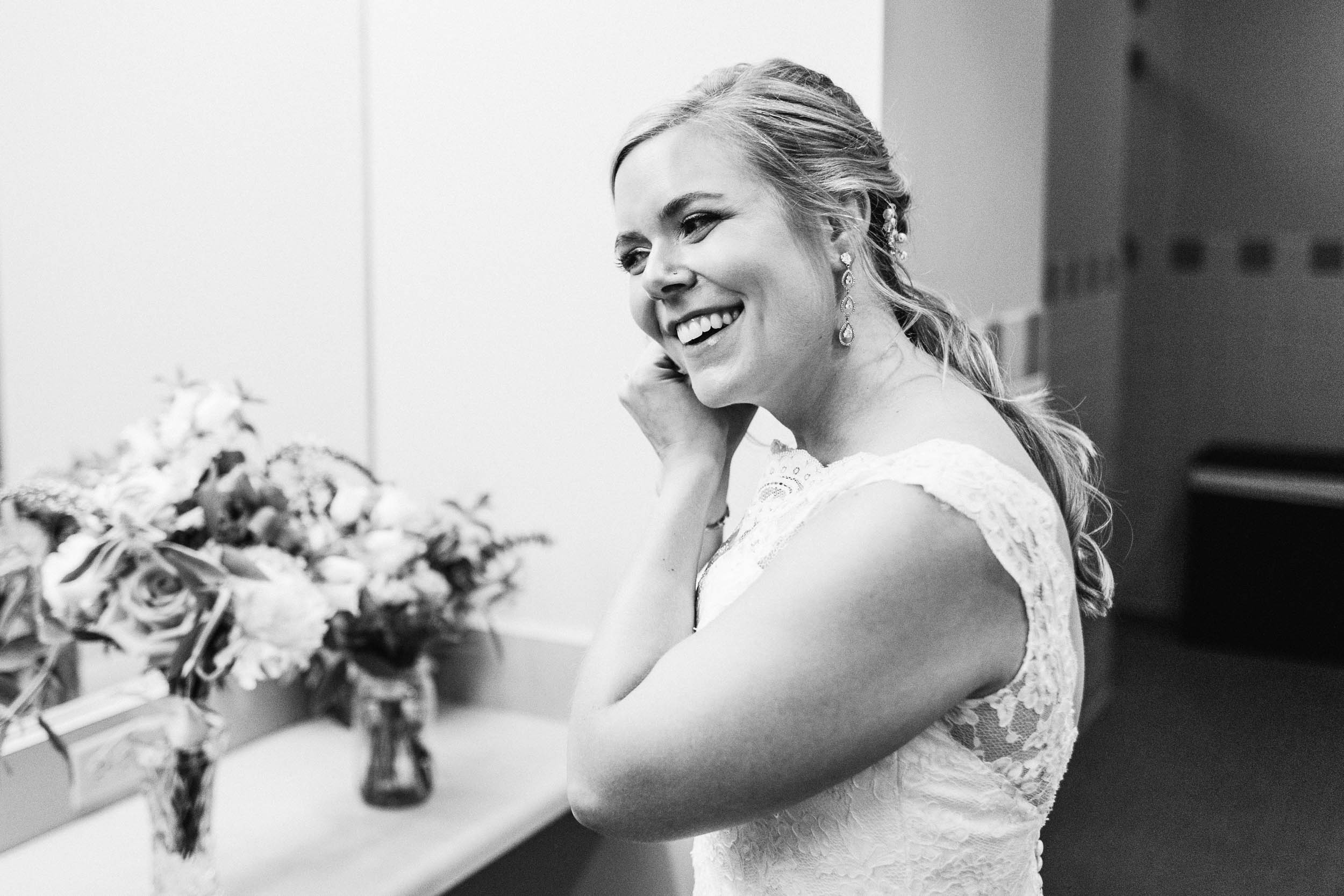 bride putting earrings in by Shea McGrath Photography Denver Colorado Wedding Photographer