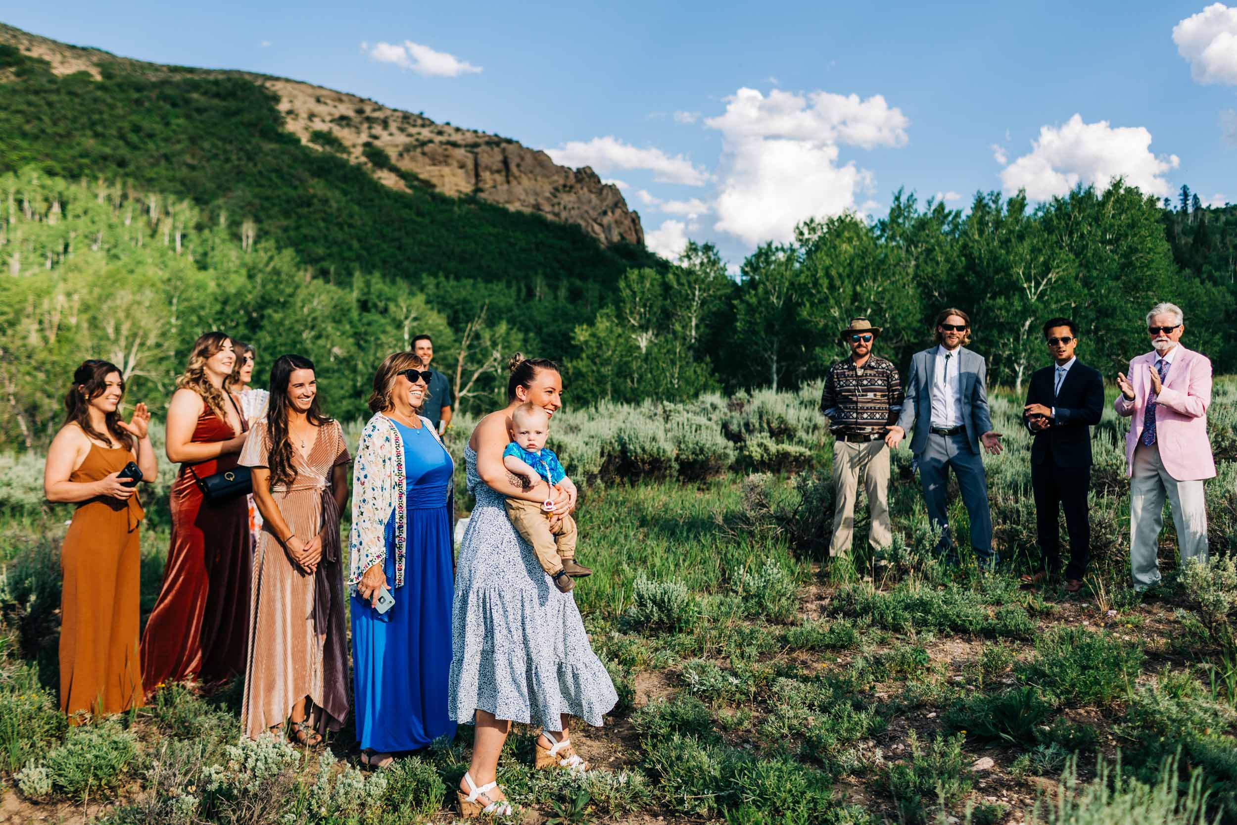 Guests watching bride walk down aisle