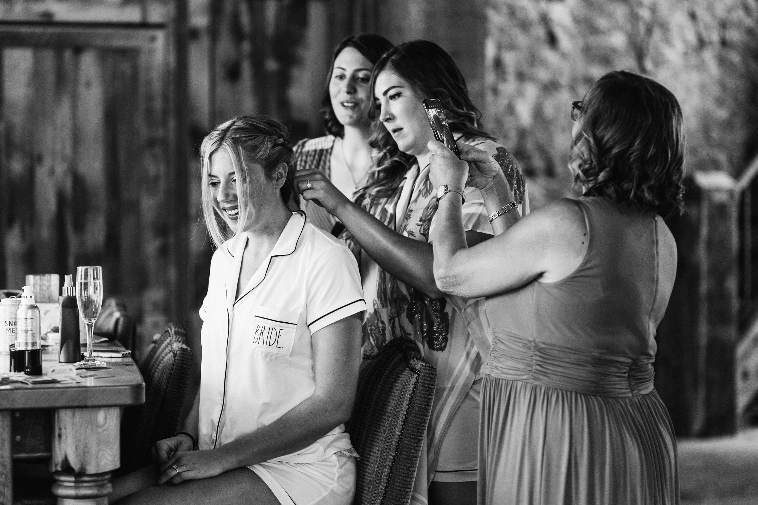 Bridesmaids doing bride's hair