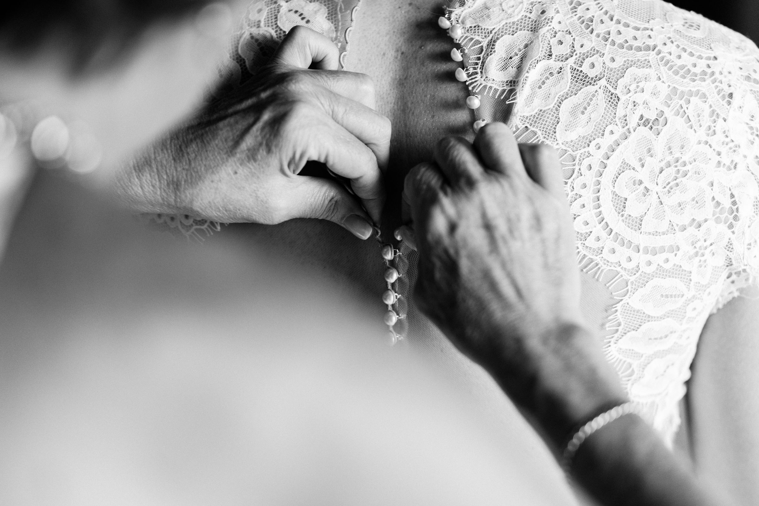Buttoning bride's dress