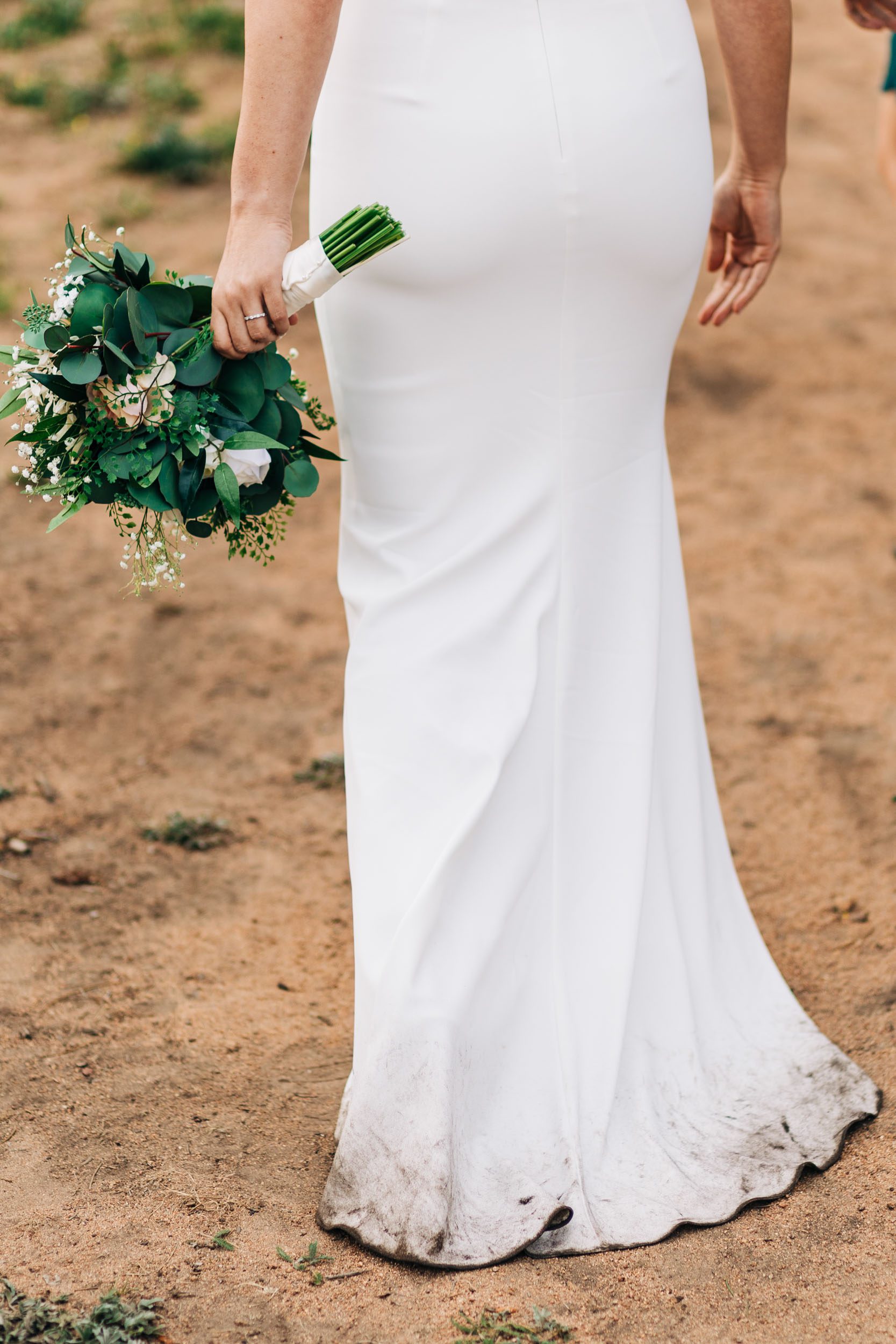 photo of bottom of wedding dress at outdoor mountain wedding