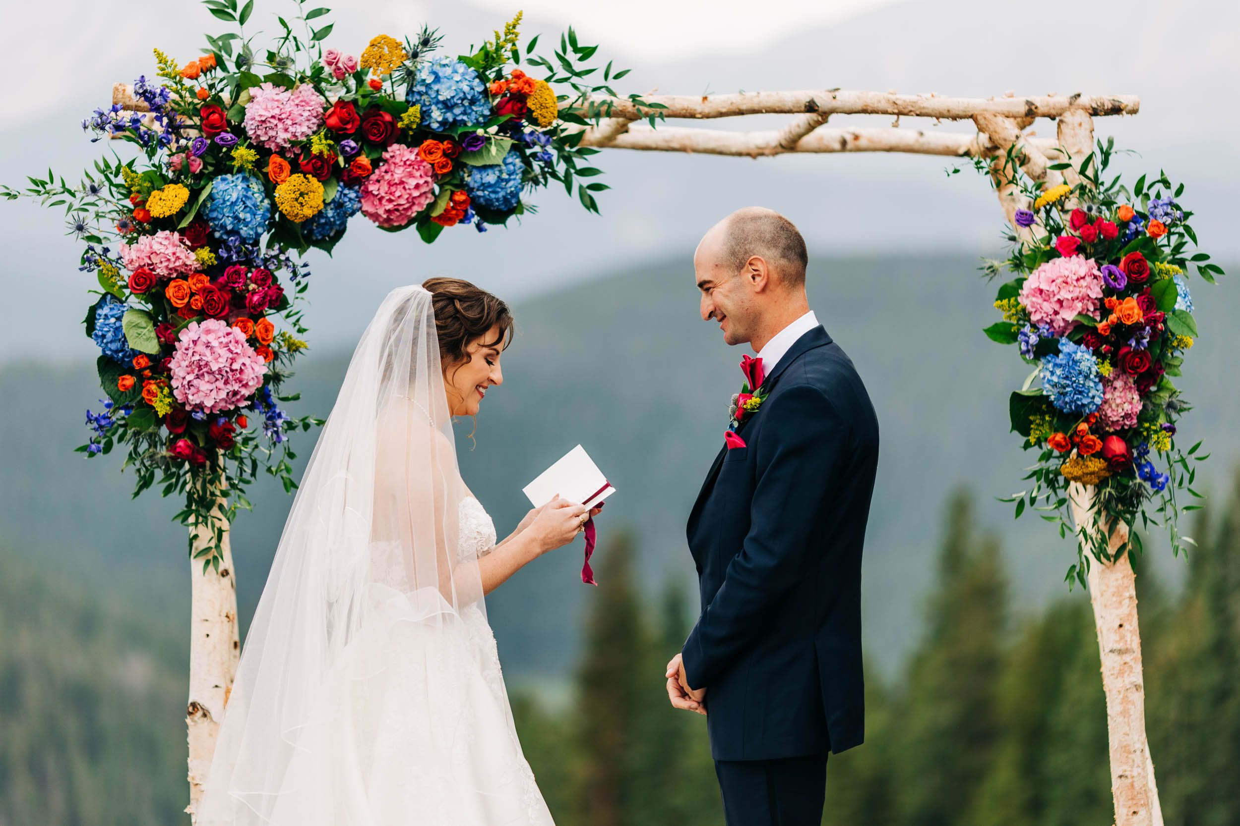 Bride reading vows at Timber Ridge lodge wedding in Keystone