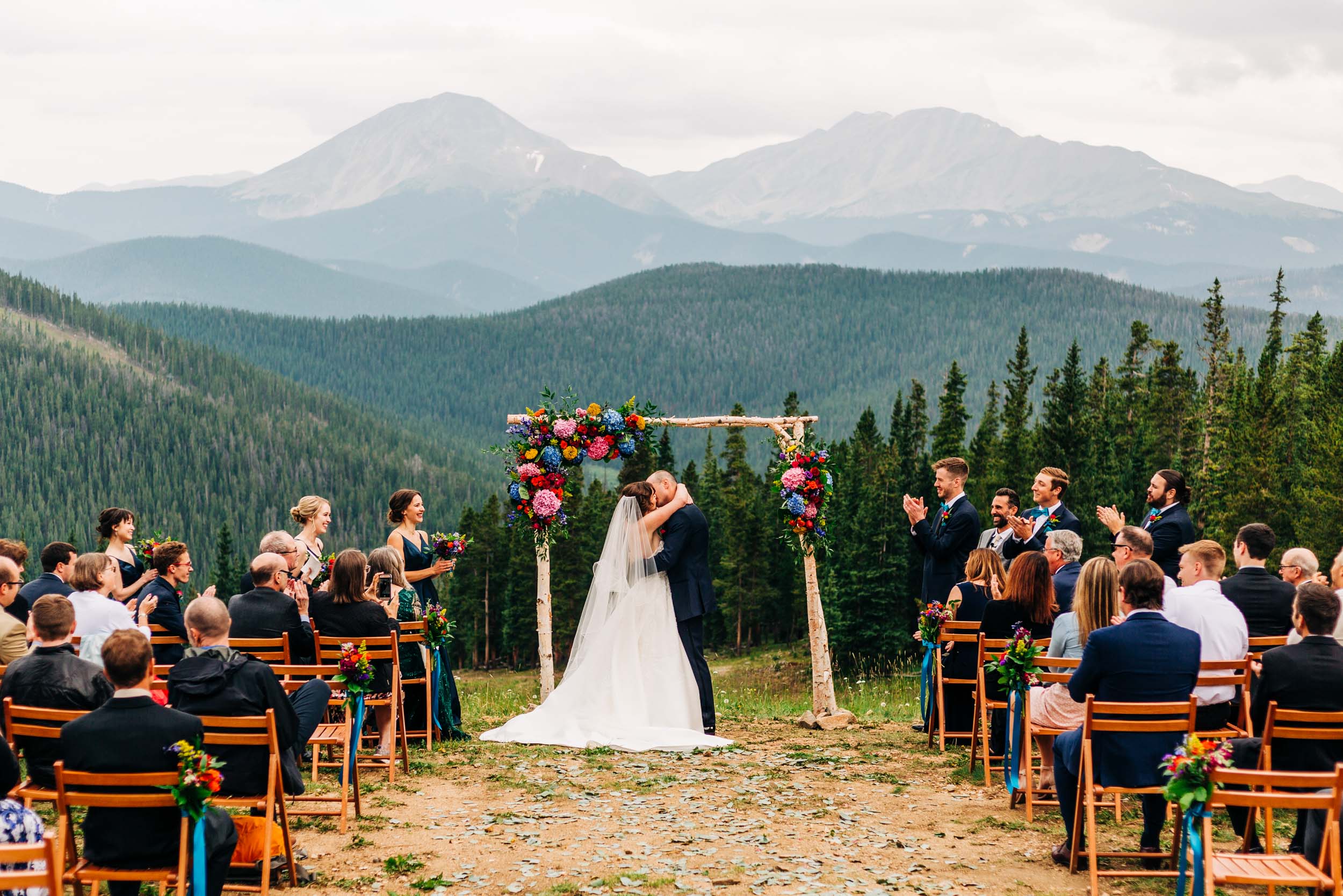 First kiss at Timber Ridge Lodge wedding ceremony in Keystone CO