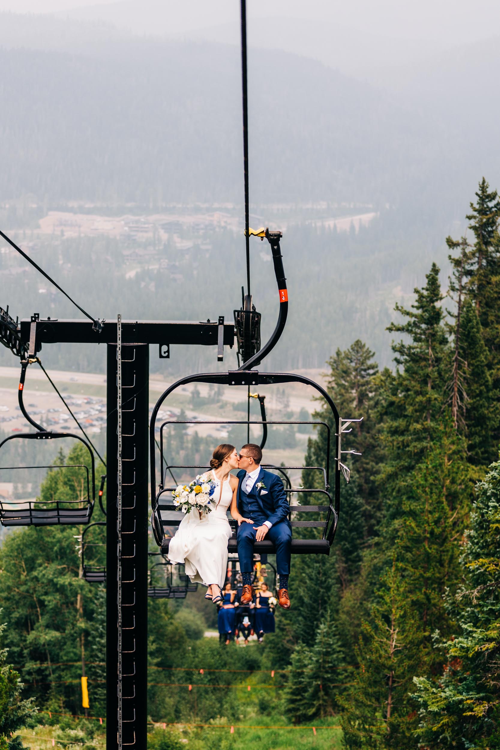 Lunch Rock wedding photo of bride and groom riding ski lift to ceremony