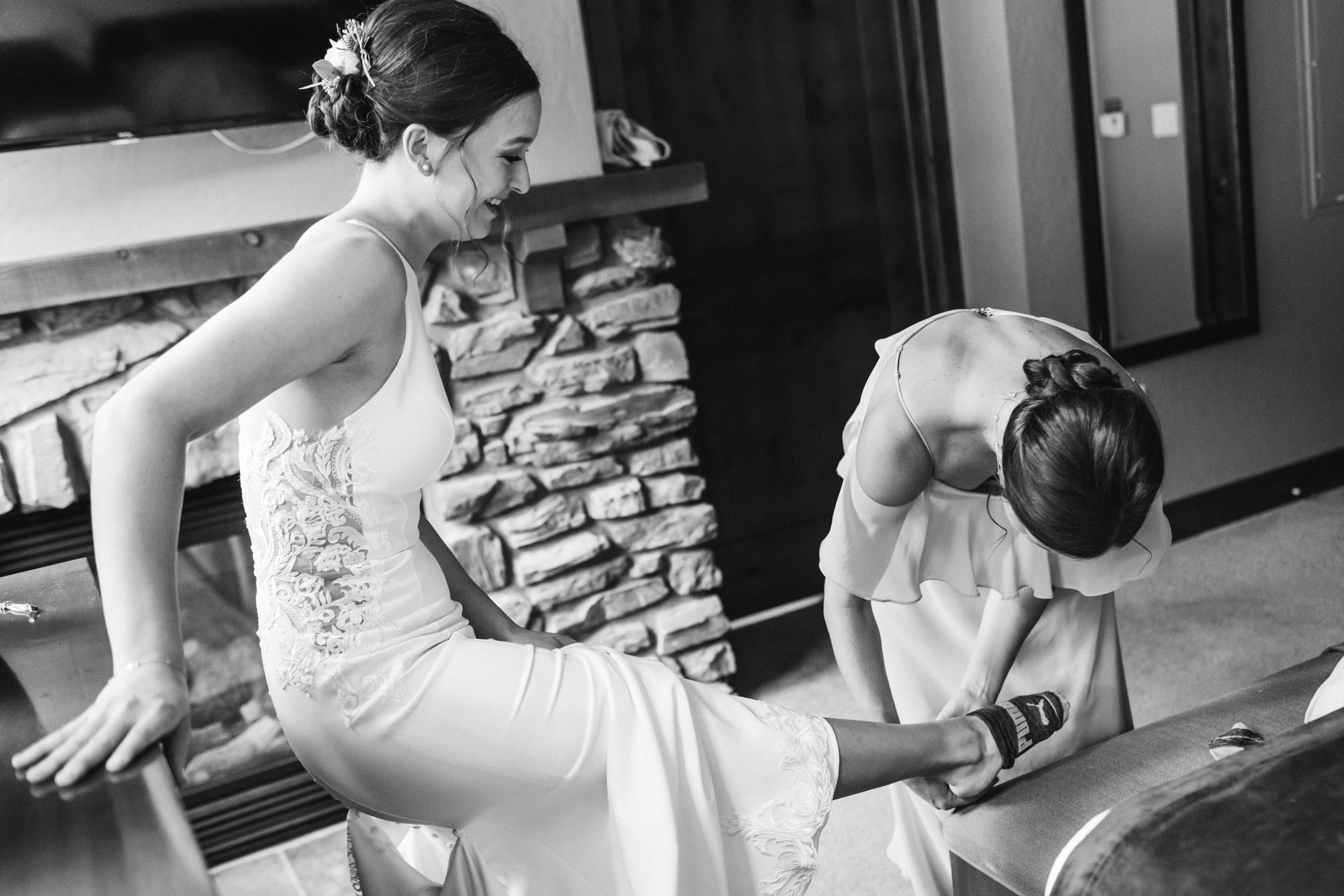 Bride putting shoes on 