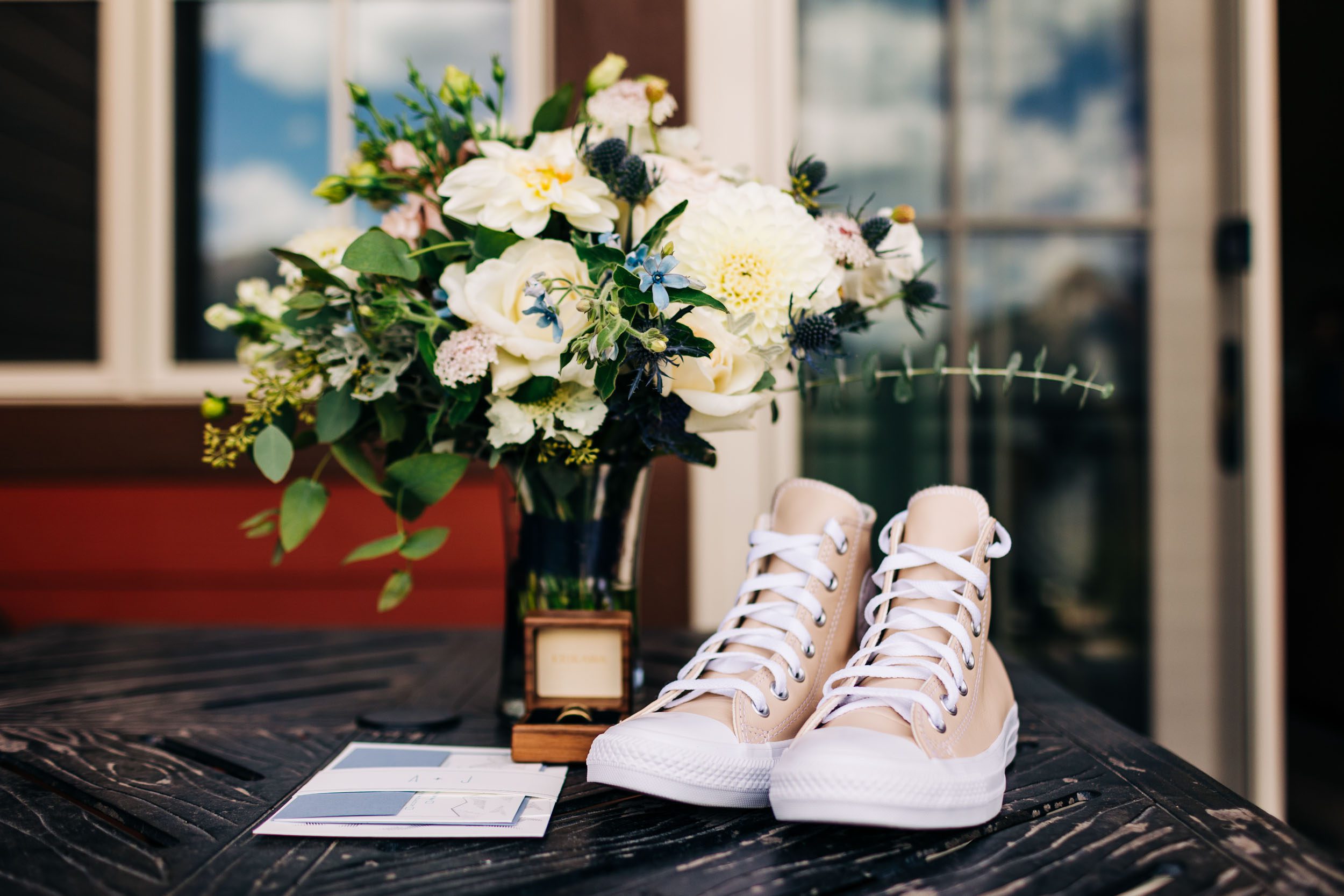 Wedding details of converse shoes and flowers