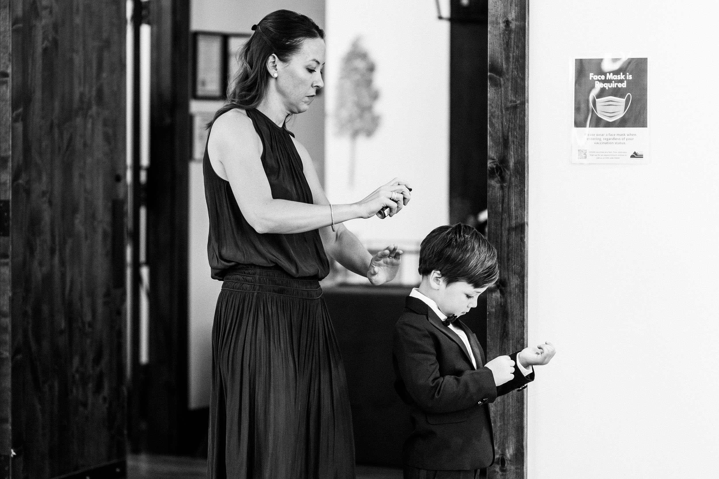 ring bearer getting ready while mom does his hair