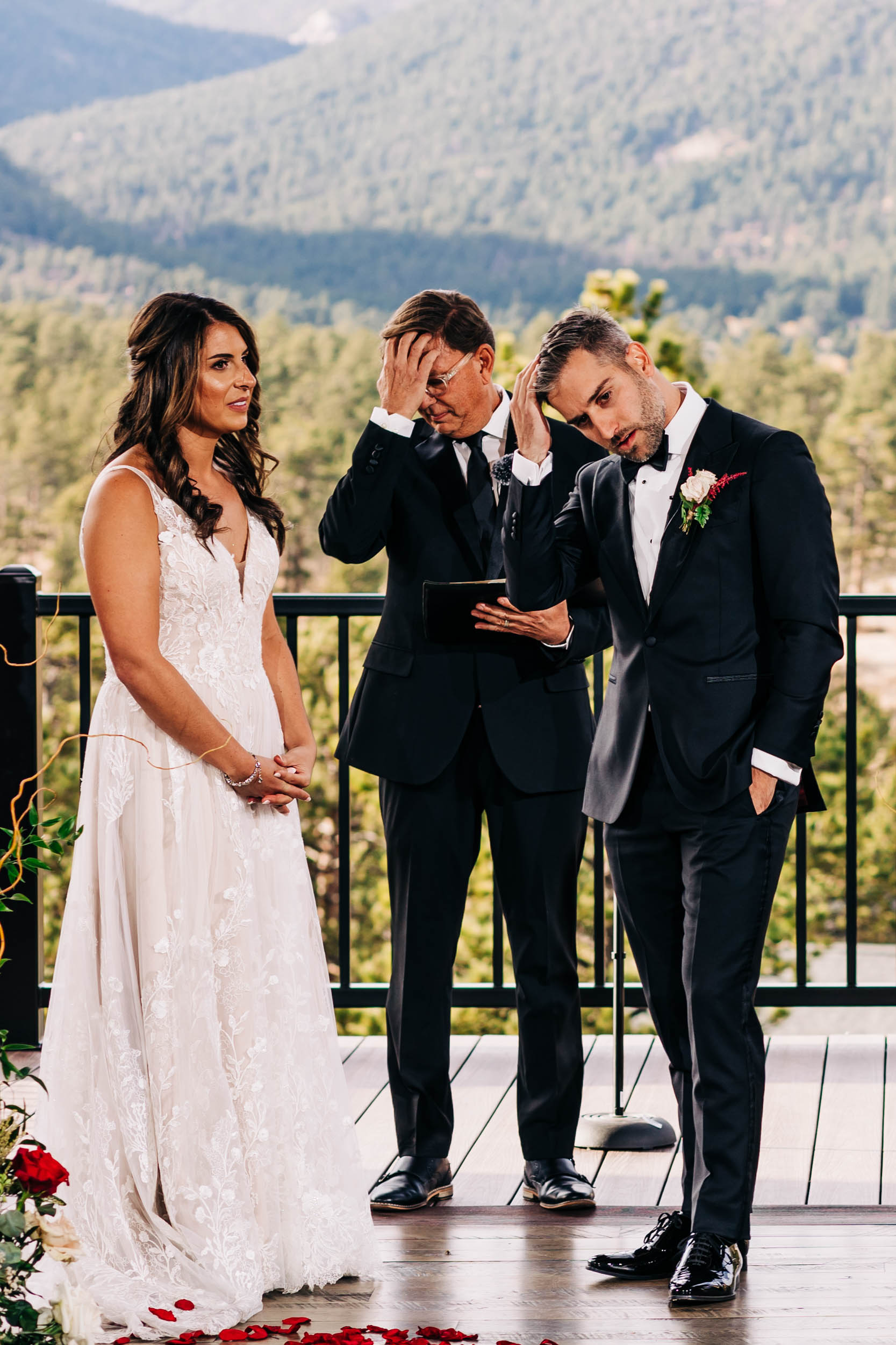 groom and officiant rubbing their heads at the same time