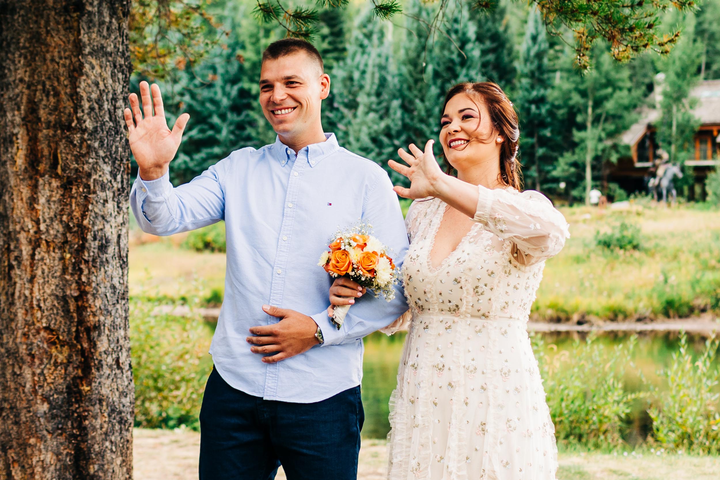 Bride and brother waving to groom