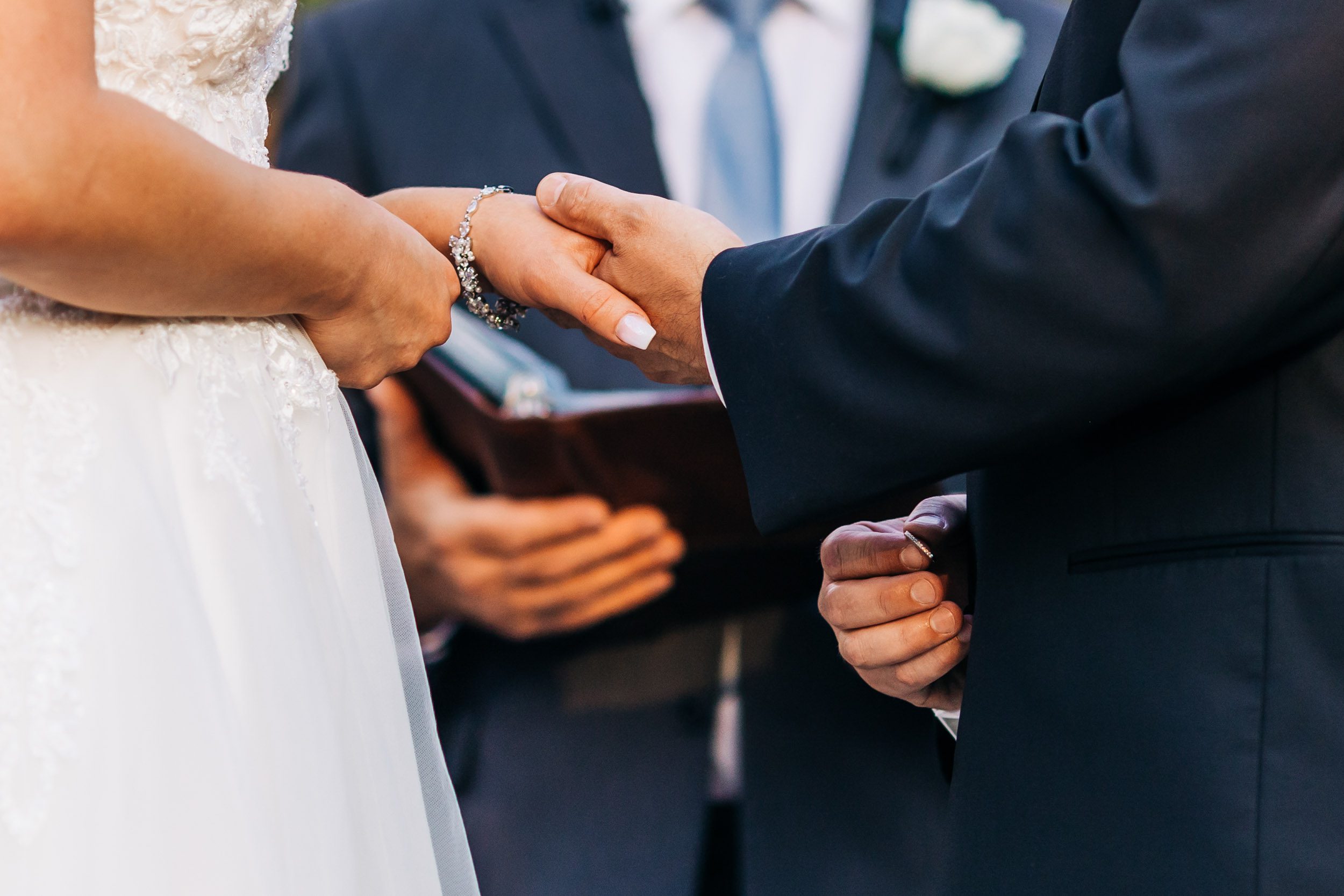 close up of ring exchange at wedding ceremony