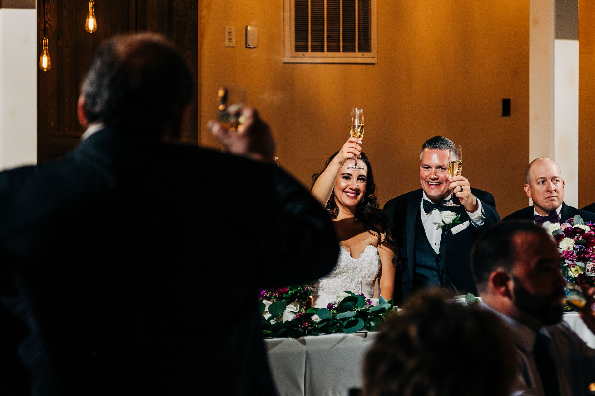 bride and groom toasting at wedding