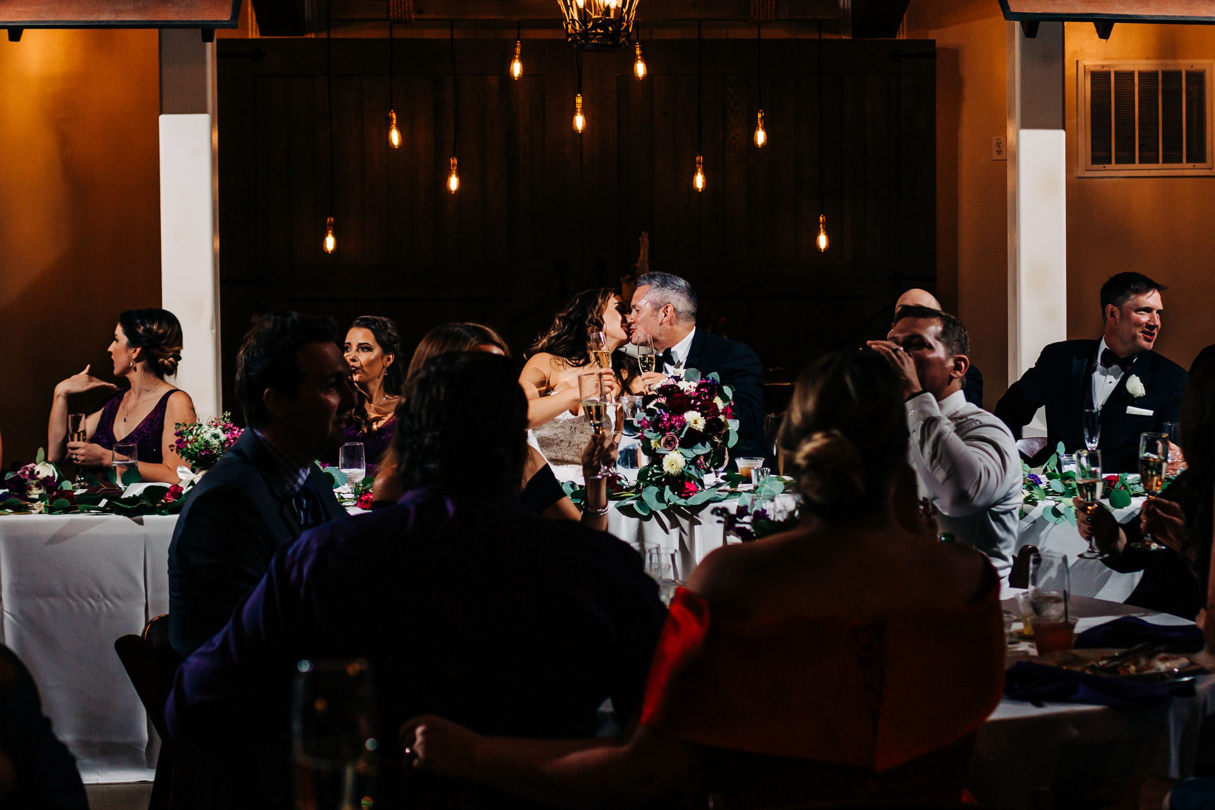 bride and groom kissing at wedding reception