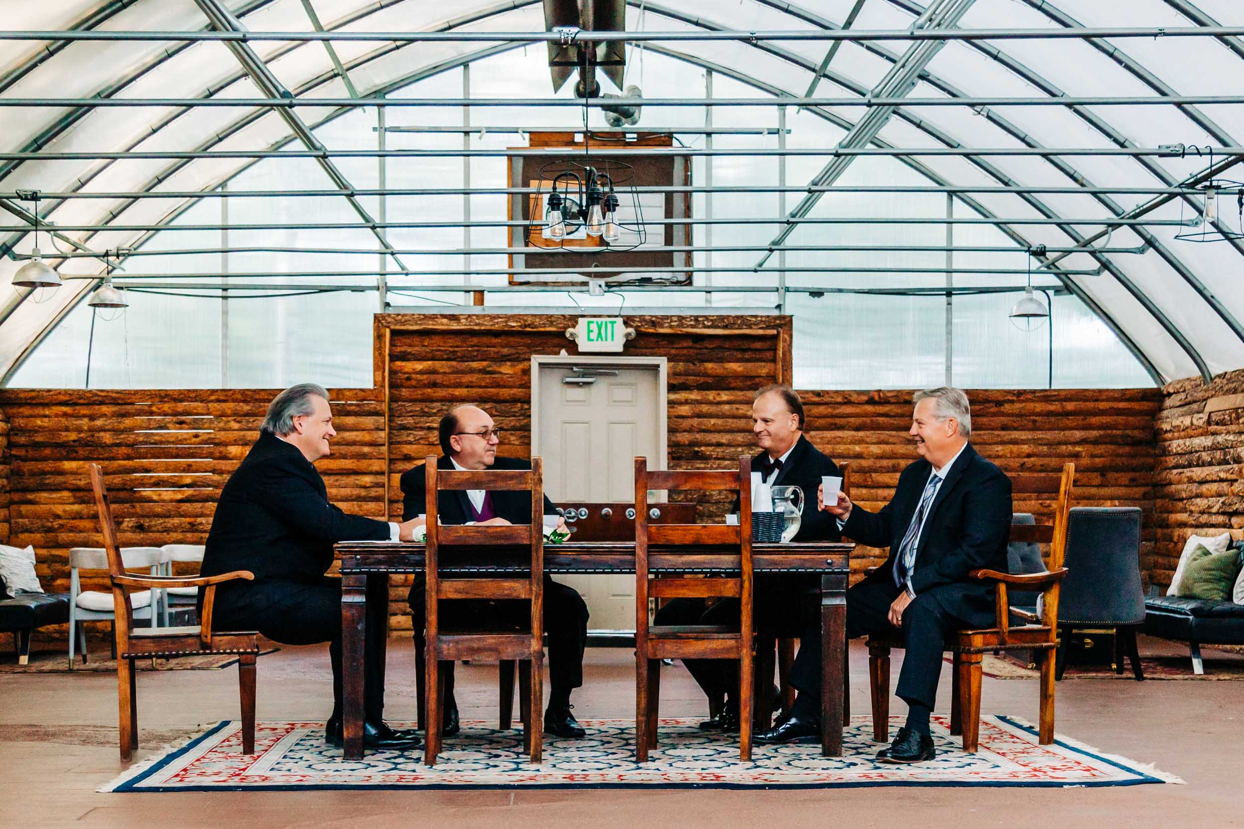 men sitting around table before wedding