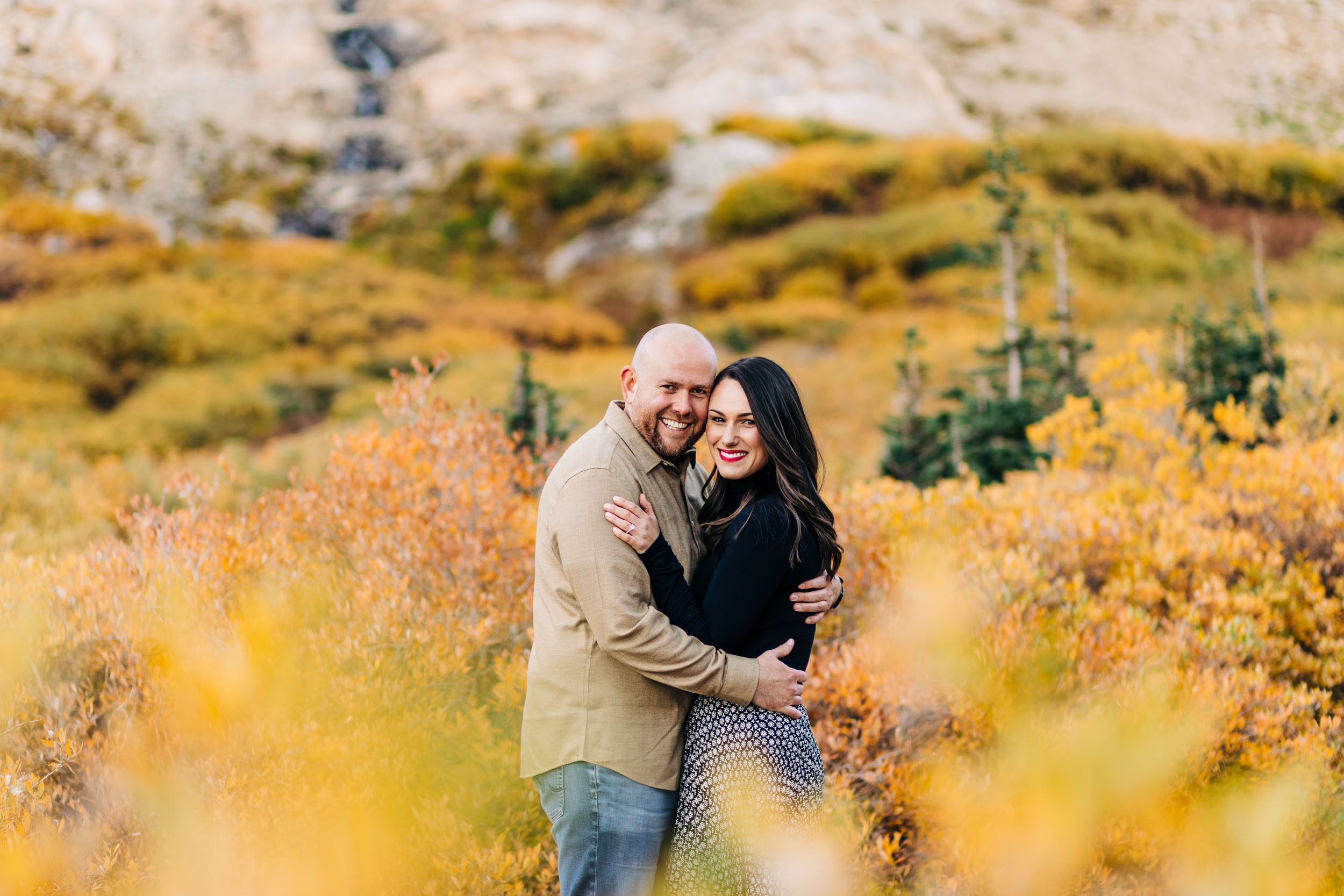 classic fall engagement photo of couple look at the camera