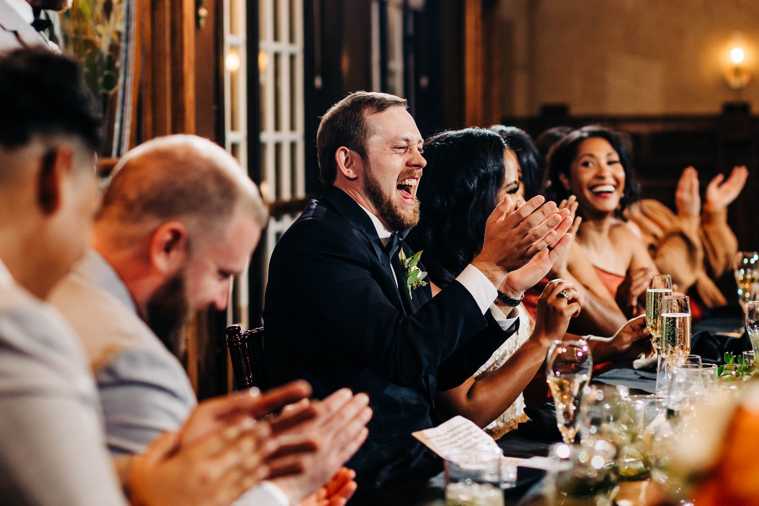 groom laughing at wedding toast