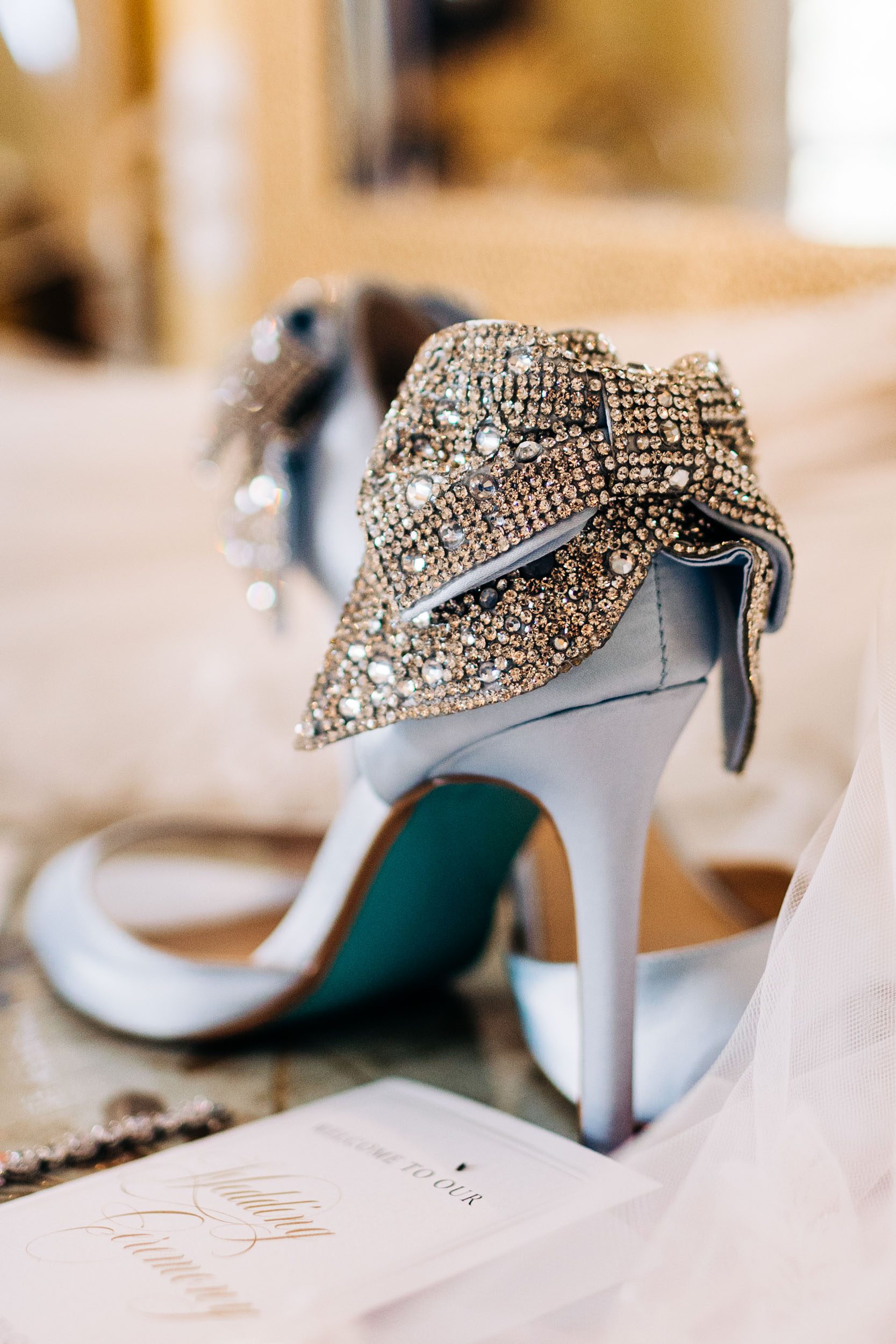 blue wedding shoes with sparkly bow on the back