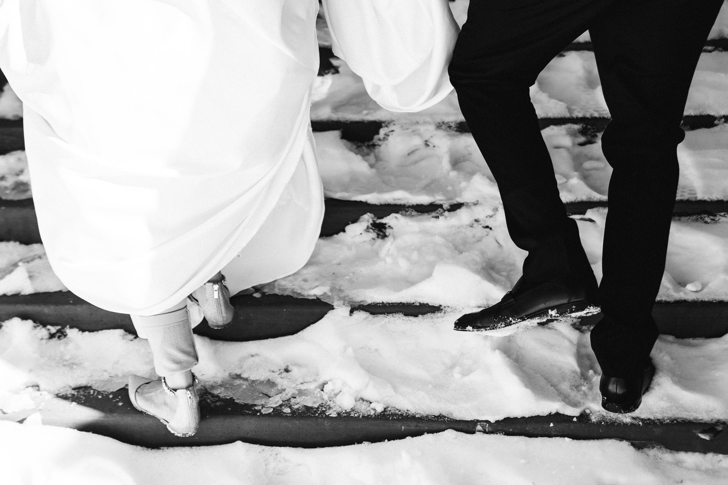 picture of bride and groom's feet walking up snowy stairs