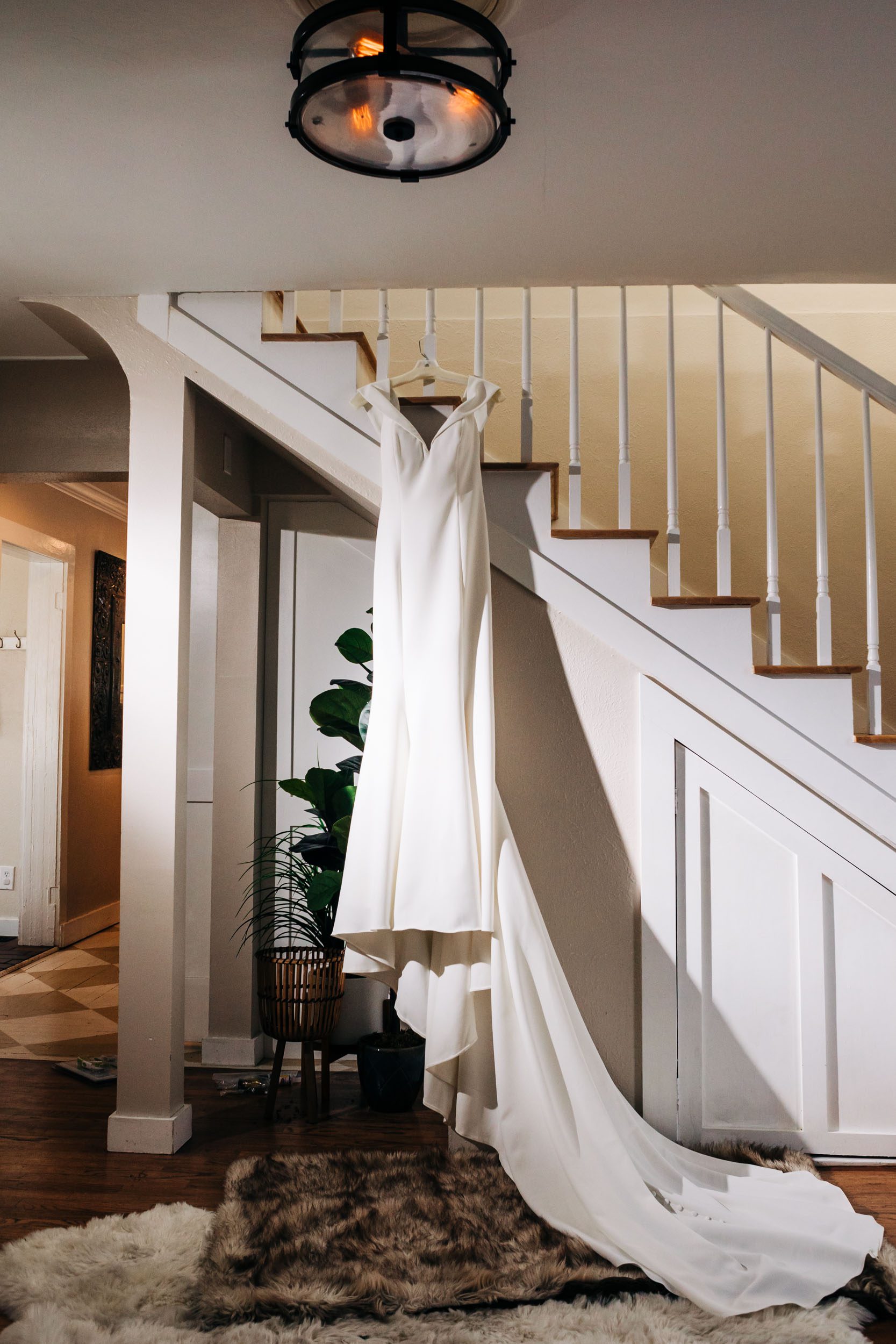 picture of wedding dress hanging by staircase