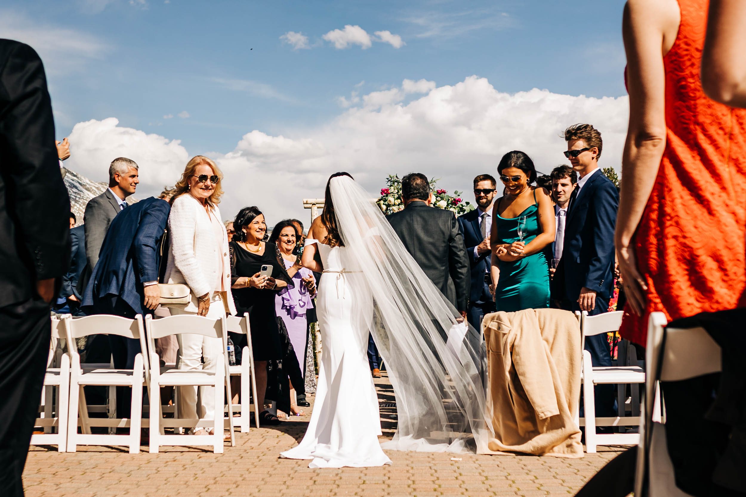 bride walking down the aisle at Ten Mile Station wedding in Breckenridge Colorado