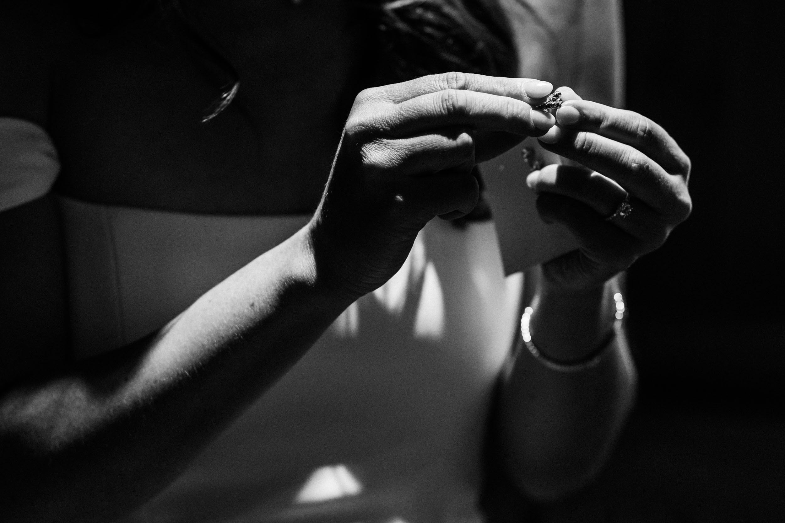 picture of bride's hands before putting earring on
