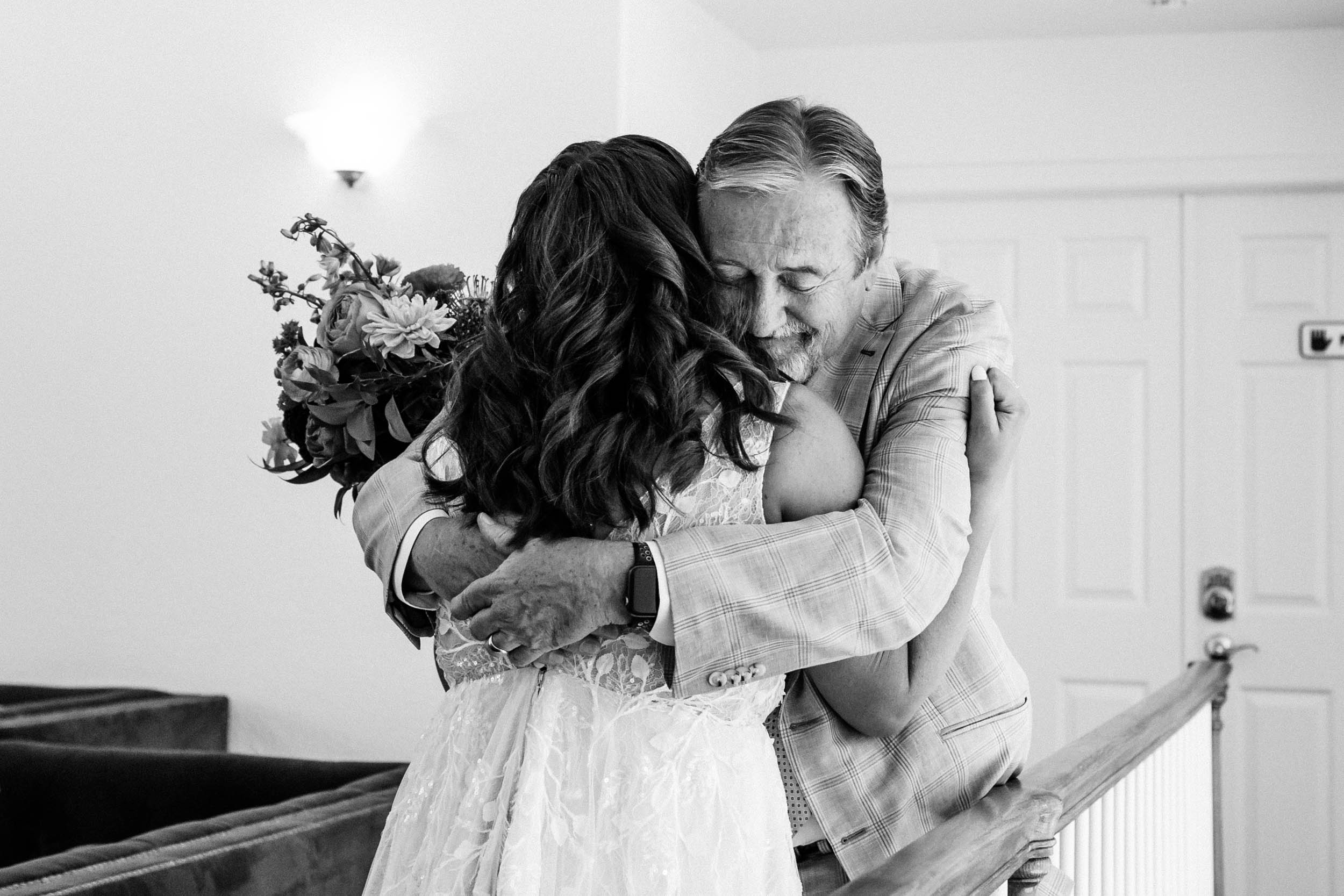 bride and dad hugging after first look