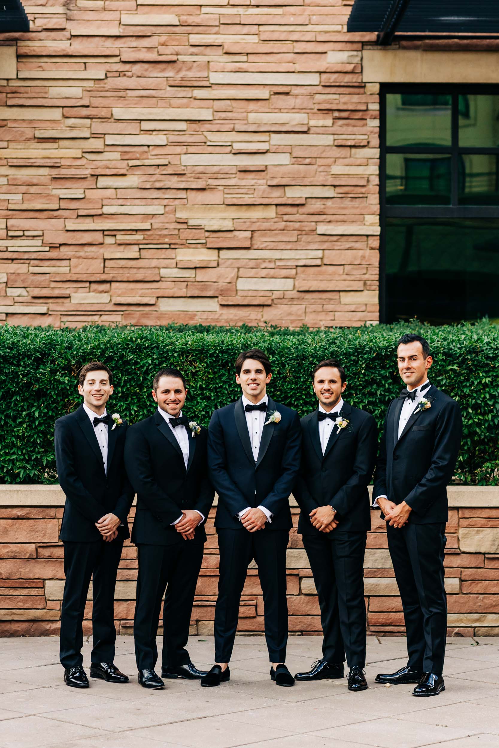 Groomsmen in courtyard of St Julien hotel and spa 
