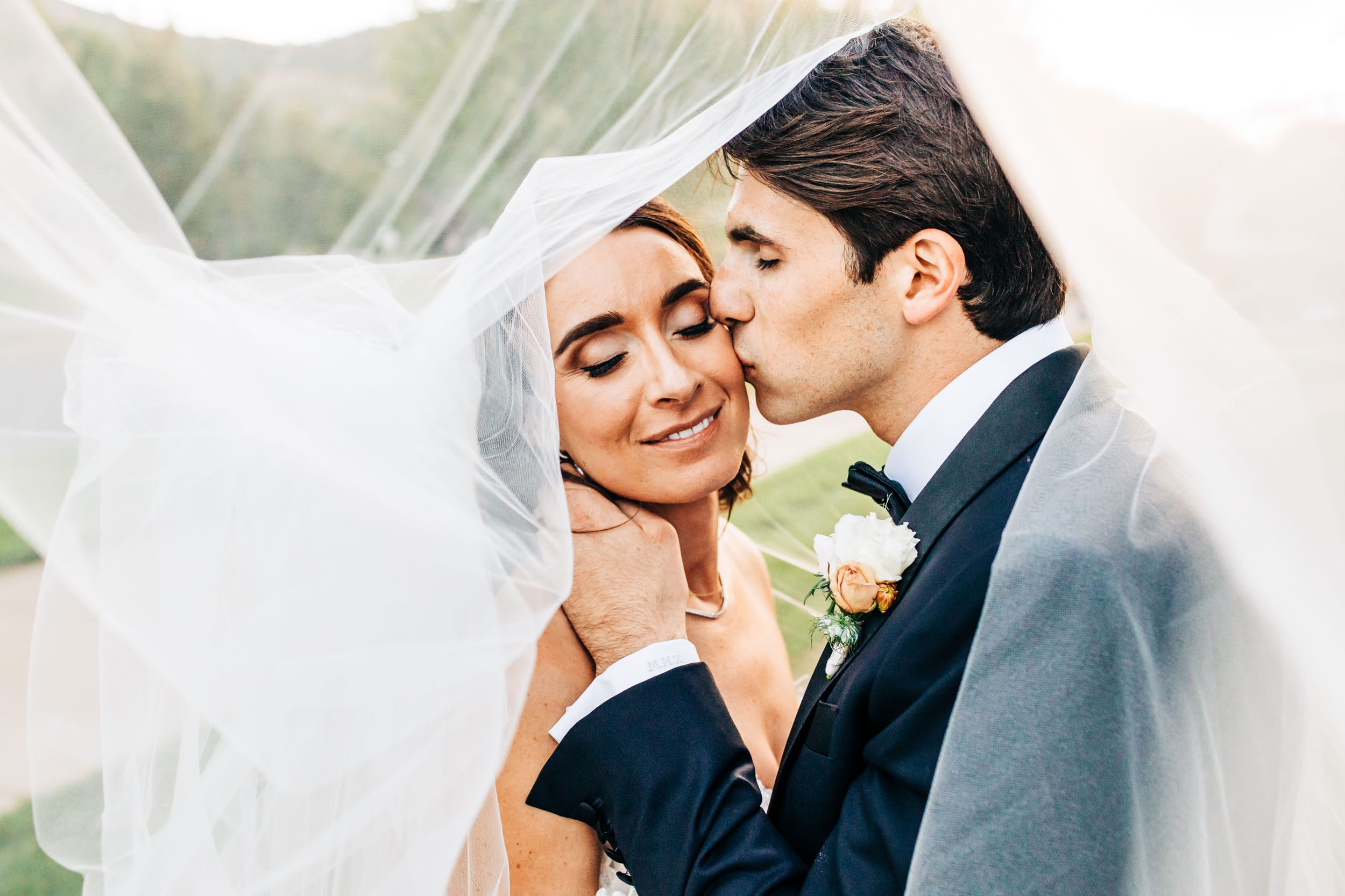 photo of wedding couple under veil