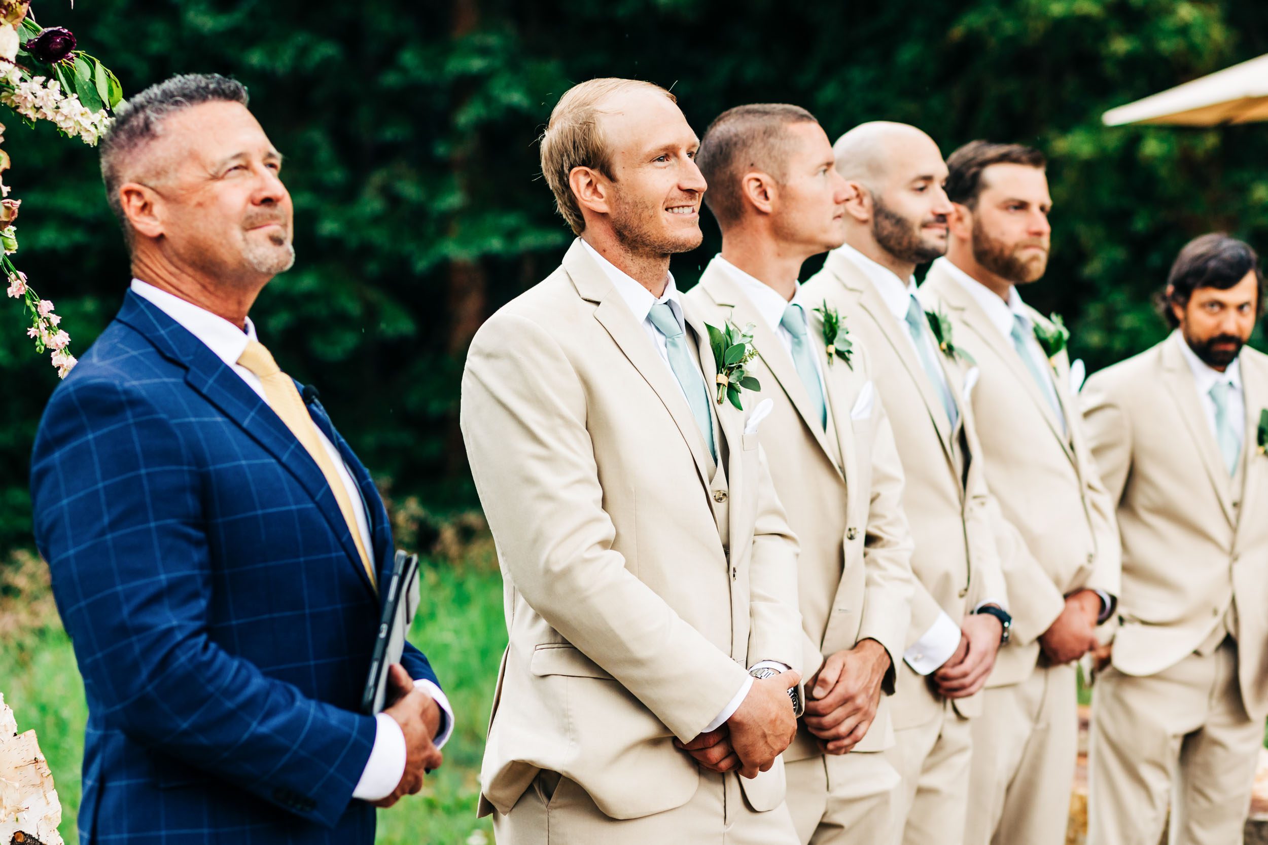 groom watching bride walk down aisle